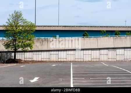 An empty car park with a motorway in the background in Glasgow, Scotland Stock Photo