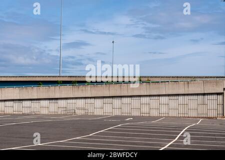 An empty car park with a motorway in the background in Glasgow, Scotland Stock Photo