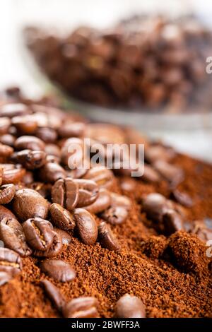 Coffee Beans and Grounds Close up. Background. Coffee beans in a glass jar in the background. Stock Photo