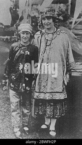 Millionairess and her unconventional attire Mrs August Belmont Jnr with her daughter Alice photgraphed in Chinese costume during a recent society fair at Bayshore Long Island 21 December 1922 Stock Photo