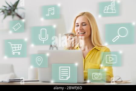 Woman Using Voice Search On Smart Phone Browsing Internet Indoor Stock Photo