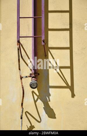 Firefighter ladder and pipeline on the building Stock Photo