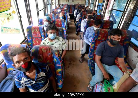 Dhaka, Bangladesh - June 01, 2020: Passengers are seen sitting inside an inter-district bus maintaining social distance. Bus service resumed after ove Stock Photo