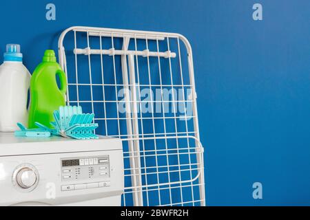 Blue clothes pins on white washing machine Stock Photo