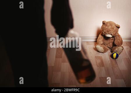 Drunk parent and little scared son. Violence against children concept. Aggression in the family. Alcohol abuse. Domestic violence Stock Photo
