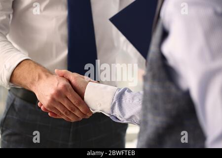 Focused photo on two people that shaking hands Stock Photo