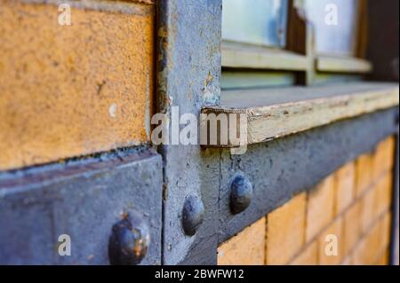 Details of a historic station building in Berlin, Germnany. You can see a weathered wooden window sill and the frame in a brick wall. Stock Photo
