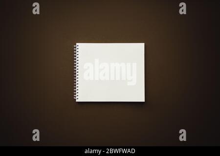 flat lay with notepad on Dark Brown background. you can put information or work on this, back to school concept, modern elementary education. flat lay Stock Photo