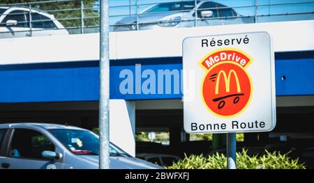 Libourne, France - May 26, 2017: Road sign indicating a place reserved for McDrive customers in the parking lot of a McDonald s restaurant on a spring Stock Photo