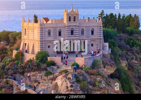 Tropea, Italy - September 09, 2019: Closeup aerial view on the Sanctuary of Santa Maria dell'Isola church on rock. Summer evening view on famous symbo