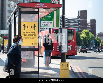 New stickers on buses remind commuters to socially distance during the COVID-19 pandemic.  Bus stop Lewisham.  May 30, 2020.      NO CONSENT FORMS SIG Stock Photo