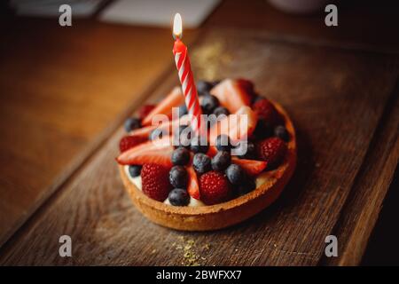 Tartlet with fruit on a wooden board Stock Photo