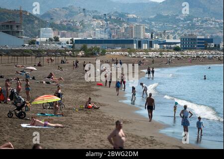 General view of Misericordia beach as people enjoy the good weather during a partial lockdown in the country. Spain is going through a plan of down-scaling towards a 'new normality' by relaxing measures that resulted from the COVID-19 outbreak. During phase 2 beaches were reopened to the public and people are allowed to sunbathe or bathe at the beach to 2 metres of distance. Also shopping malls can reopen and clients can eat and drink inside bars or restaurants without restrictions while they use face masks and keeping a safety distance. Stock Photo