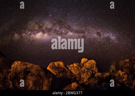 Rock formations under starry sky and Milky Way galaxy at night, Damaraland, Namibia, Africa Stock Photo