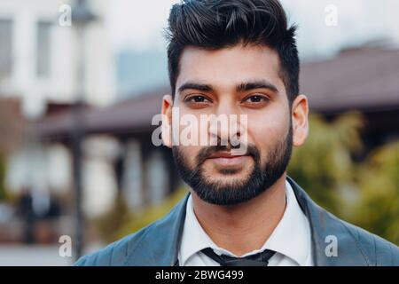Stylishly dressed Indian bearded man walks down the street. Stock Photo