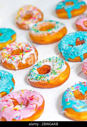 Colorful Donuts turquoise and pink, pattern. Donuts Set on White Background. Doughnuts with multi colored glaze. Doughnuts are traditional sweet pastr Stock Photo