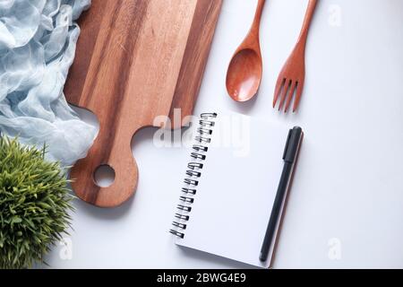 diet plan concept with notepad and chopping board on white background  Stock Photo
