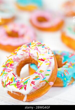 Colorful Donuts turquoise and pink on White Background close-up. Doughnuts with multi colored glaze. Doughnuts are traditional sweet pastries. beautif Stock Photo