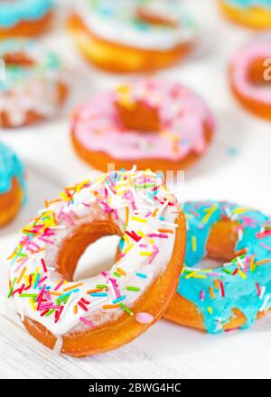 Colorful Donuts turquoise and pink on White Background close-up. Doughnuts with multi colored glaze. Doughnuts are traditional sweet pastries. beautif Stock Photo