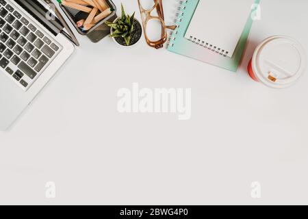 office stuff with with notepad, laptop and coffee, glasses, notepad top view Stock Photo