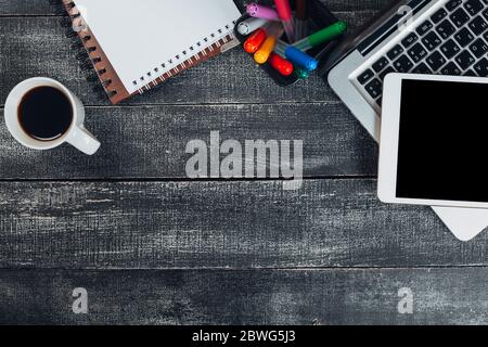 office stuff with notepad, laptop and coffee cup mouse notepad top view shot. Stock Photo