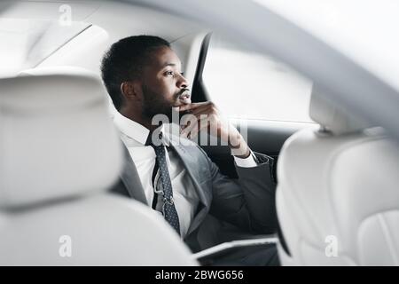 Pensive Businessman Sitting In Car Thinking Commuting To Work Stock Photo