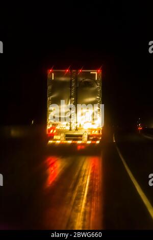 Semi truck on Interstate 84 over the Blue Mountains on a rainy November night, Oregon, USA [No property release; available for editorial licensing onl Stock Photo