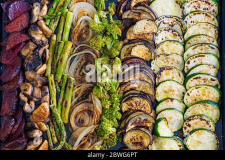Different types of roasted vegetables in the oven Stock Photo