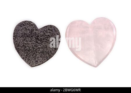 Rose quartz heart and black foam heart isolated on white background Stock Photo