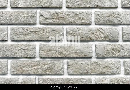 Brick wall of beige bricks. Background and texture of brickwork. Stock Photo