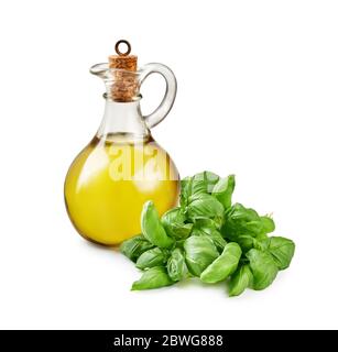 Glass jar of olive oil with basil leaves isolated on white. Stock Photo