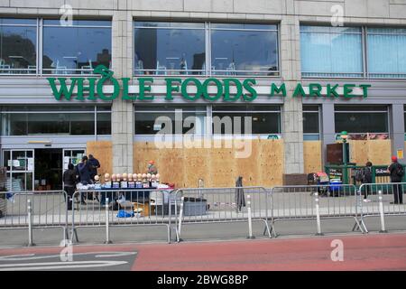 Whole Foods Market windows boarded up to prepare for potential vandals and looters as protests over the death George Floyd while in custody of police in Minneapolis continue. June 1, 2020, Union Square, Lower Manhattan, New York City. Stock Photo