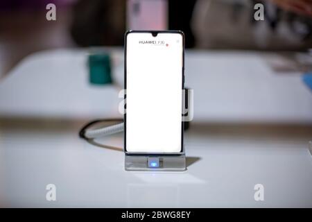 Moscow, Russia - October 04, 2019: Huawei P30 Pro smartphone on phone stand. front view, close up, soft focus. backround in blur Stock Photo