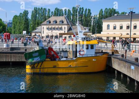 A small yellow fishing boat in Oslo, Norway Stock Photo