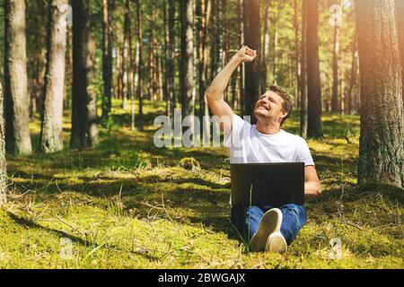 cheerful freelancer with hand raised working outdoors Stock Photo