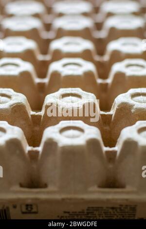 A lot of empty cardboard egg cartons in a row. Bottom of egg trays. Stock Photo