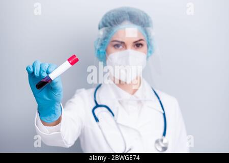 Closeup photo of virology professional experienced doc hold blood probe covid patient positive result wear coat mask facial plastic protection shield