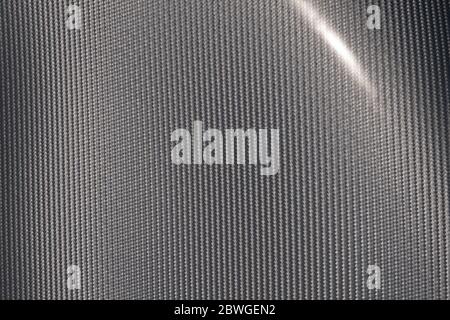 Close up of grey carbon fiber pattern texture surface. Texture and pattern background. Modern technology and material concept. Stock Photo