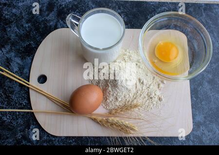 https://l450v.alamy.com/450v/2bwget2/ingredients-for-making-flour-products-or-dough-flour-egg-milk-close-up-the-view-from-the-top-2bwget2.jpg