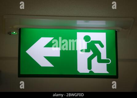 Green emergency Exit Sign in a UK office Stock Photo
