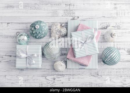 Gift boxes with different christmas decorations on white wooden background, top view Stock Photo