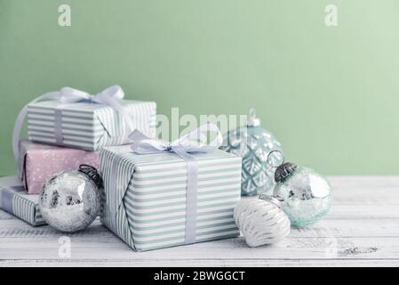 Gift boxes with different christmas decorations on green background Stock Photo
