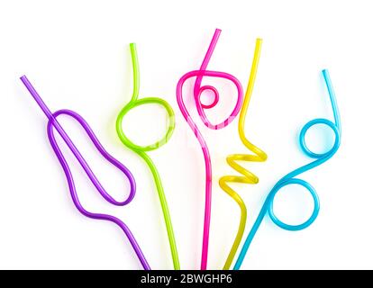 Multi-colored semi-transparent in many shapes straw. Drinking straws in the colors blue, purple, pink isolated on a white background Stock Photo