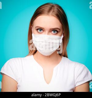 Young woman in a protective mask on an isolated background. Isolated, square format Stock Photo