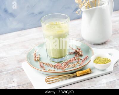 Green matcha tea latte drink in tall glass Stock Photo