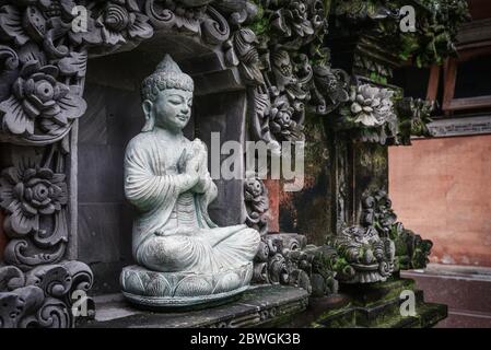BALI, INDONESIA - JANUARY 12, 2018: Stone Buddha sculpture outdoor on Bali, Indonesia Stock Photo