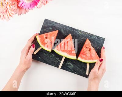 Watermelon slice popsicles on marble tray Stock Photo