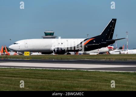 Titan Airways Boeing 737-400 G-POWS taxiing in at London Southend Airport, Essex, UK for unloading. Serving ASL Airlines Amazon freight flights Stock Photo