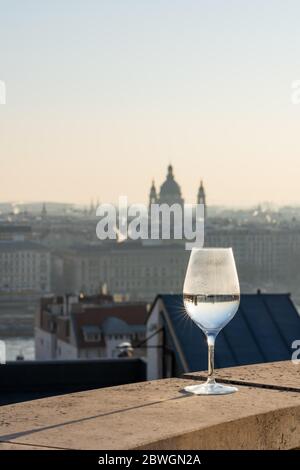 Refelction of St. Stephen basilica in wine glasses and vague silhouette in the background Stock Photo