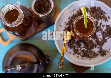 black tea on a vintage background, for a hot day, organic with a bottle Stock Photo